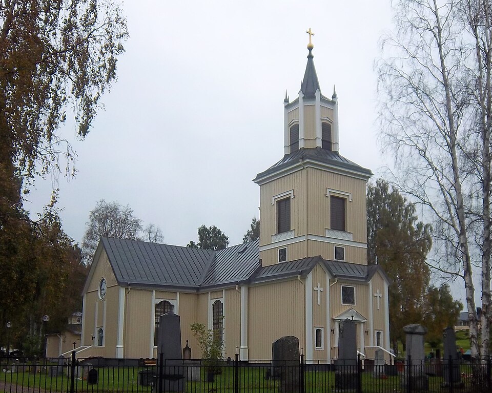 Älvsbyn church on a cloudy day in the fall, photographed between the church and the church village