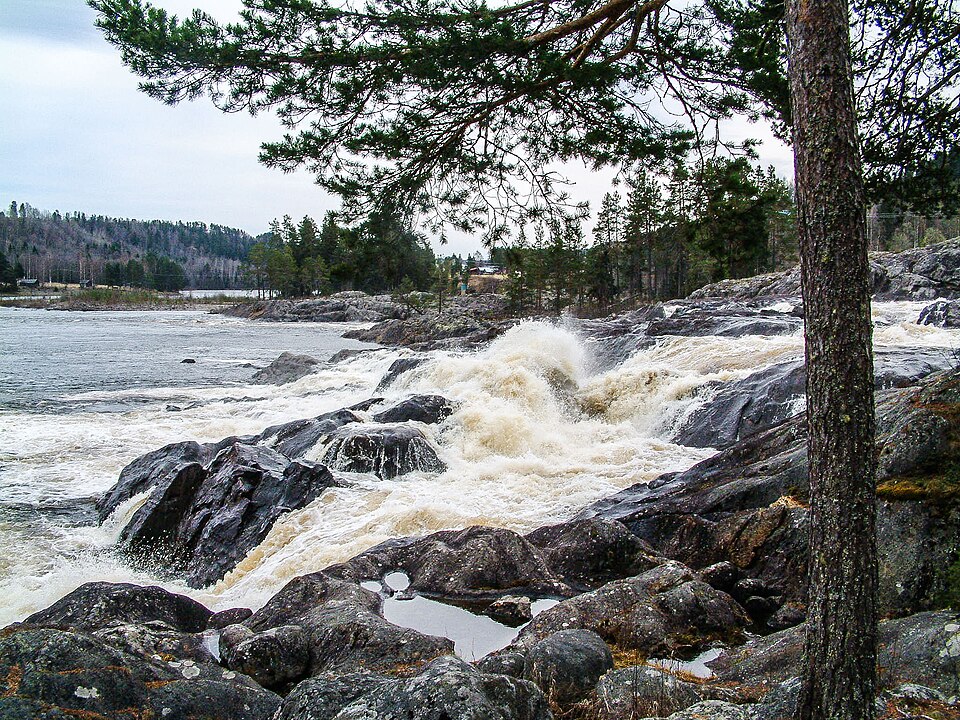 Nämforsen rapids in the river Ångermanälden near Näsåker, Ångermanland, Sweden. The site is famous for its large concentration of prehistoric rock carvings along the riverbanks. A hydroelectric power 