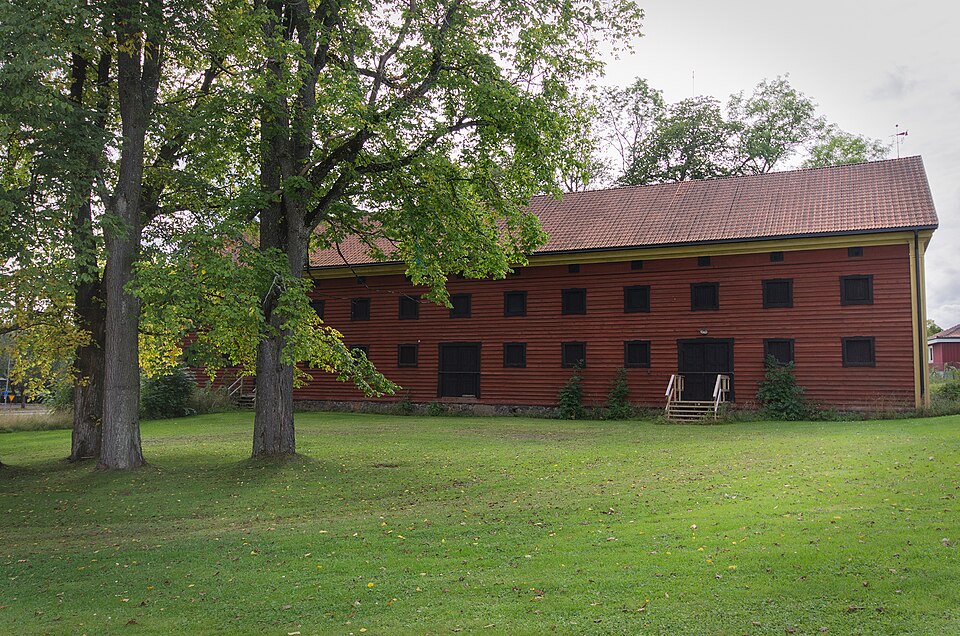 A large grain storehouse of wooden construction on a stone foundation.